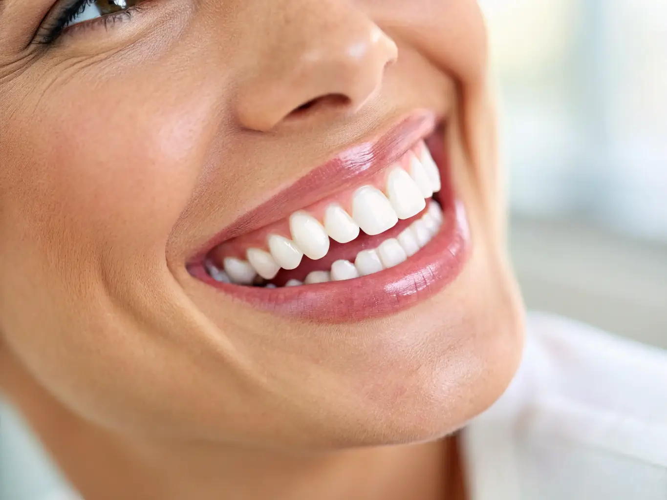 A close-up shot of a patient's radiant smile after undergoing a smile design procedure at Kalm Dentistry.